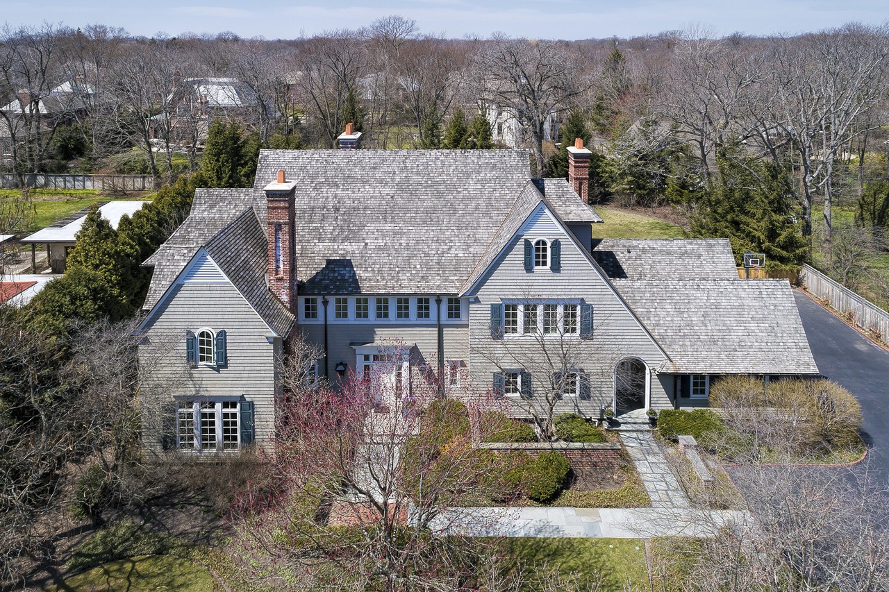 a large house with trees in the background