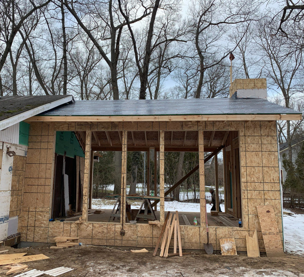 a building under construction with trees in the background